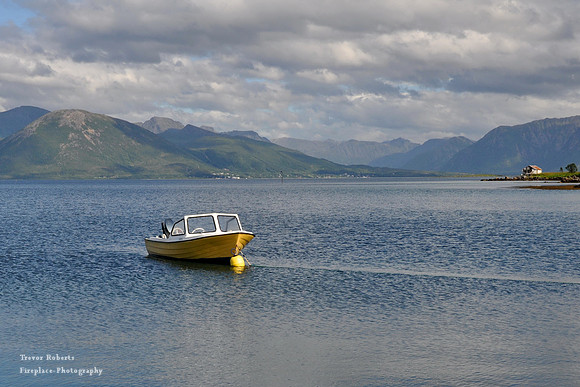 Small yellow boat in the fjord