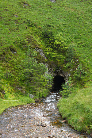 Stream disappearing into a cave