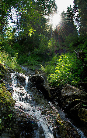 small waterfall in the sunlight