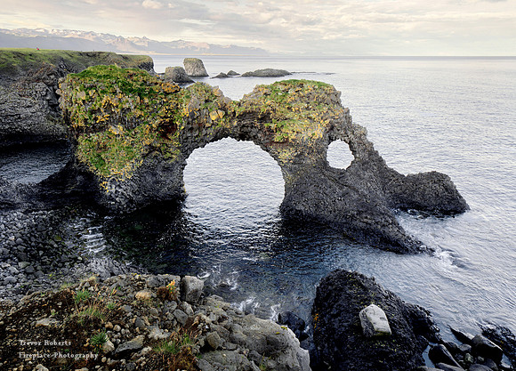 Holes in the rock along the coast at Hellnar