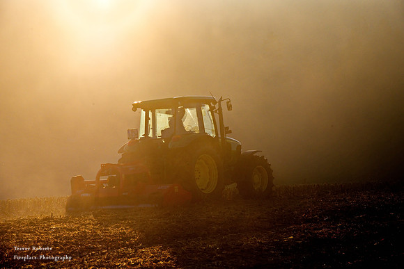 Kirchstetten - Tractor on a foggy field as the sun sets