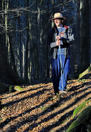 Young man in the forest shadows