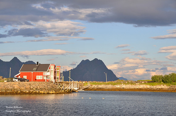 Red house at the edge of the Fjord